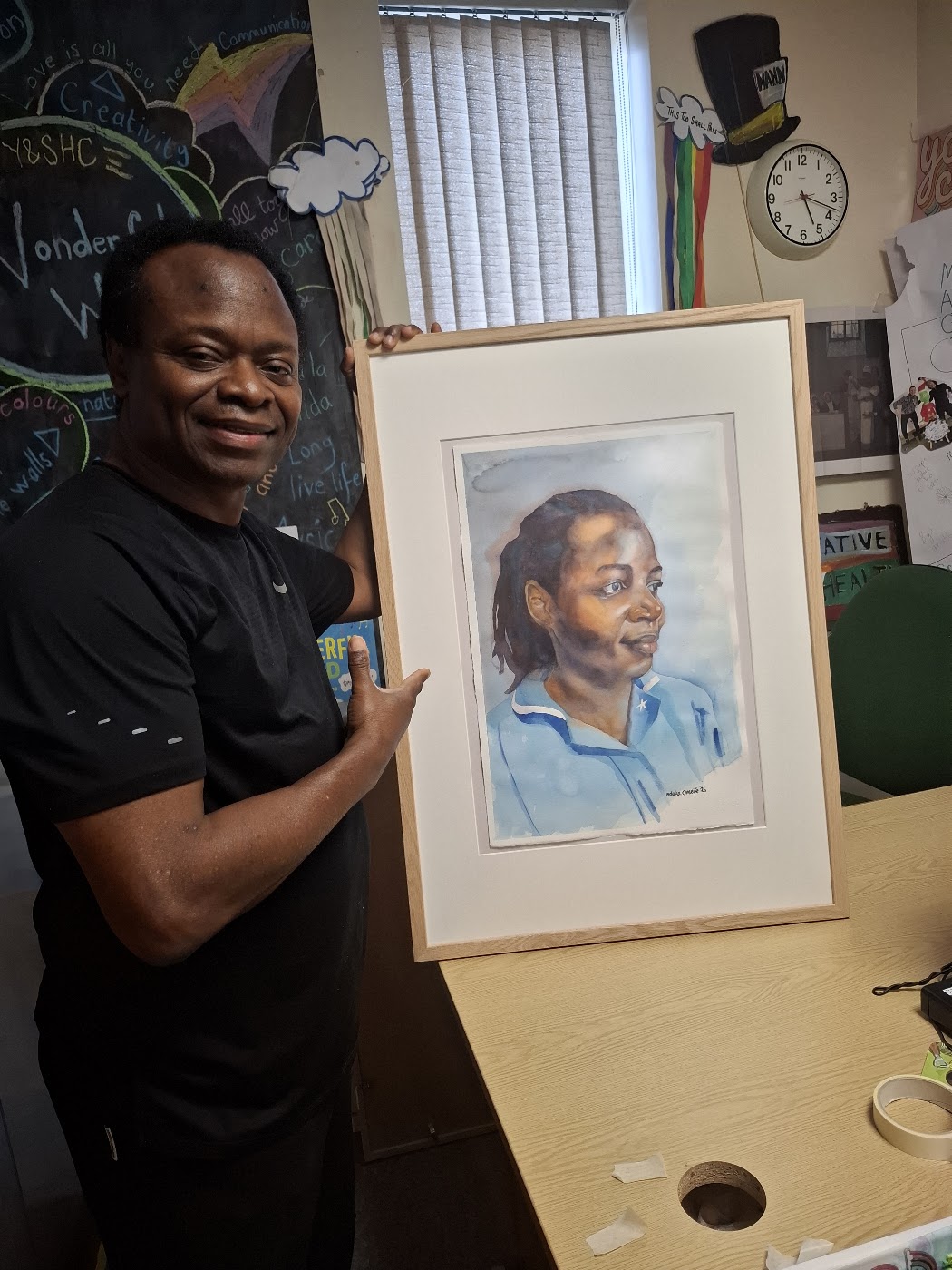 Nduka Omeife with his Black History Month portrait, York Hospital exhibition 2026, photograph 4